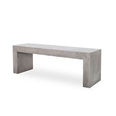 a concrete bench sitting on top of a white floor