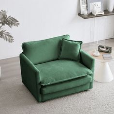 a green chair sitting on top of a white rug