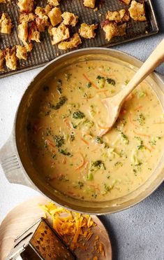 a pan filled with broccoli cheese soup on top of a table