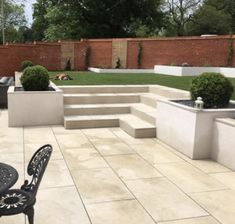 an outdoor patio with seating and landscaping