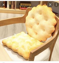 a wooden chair with a cookie shaped seat on it