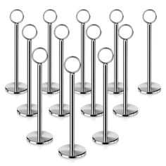 six metal poles with circular rings on them and one is standing in the same direction