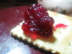 a piece of cracker with jelly on it