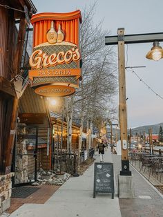 an outdoor restaurant called grecos pavaria on the side of a road