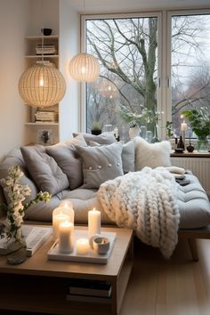 a living room filled with lots of furniture next to a large window covered in candles