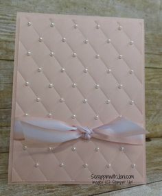 a card with pearls and a bow on it