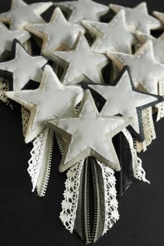 some white and black stars are on top of each other, with lace around them