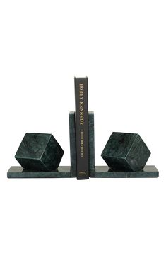 two bookends made out of marble with books on each side and one is green