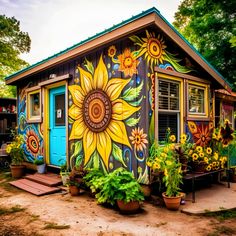 a colorful painted shed with potted plants and sunflowers on the front door