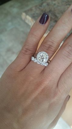 a woman's hand with a diamond ring on it