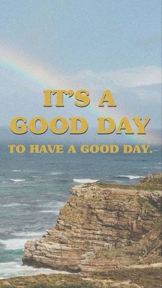 there is a rainbow in the sky over the ocean and rocks with text that reads, it's a good day to have a good day