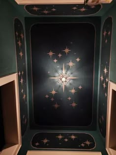 the ceiling is decorated with stars in green and white colors, as well as black background