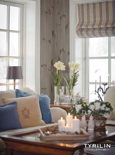 a living room filled with furniture and flowers