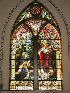 a stained glass window with two figures in it