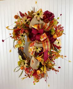 a fall wreath hanging on the side of a door