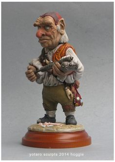 a figurine of an old man holding a cat