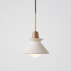 a white and wooden light hanging from a ceiling fixture with a black cord attached to it