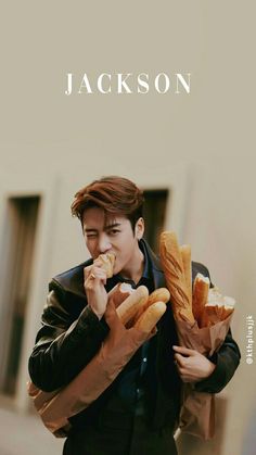 the man is eating bread while holding his hands in each other's pockets,