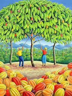 two people standing under a tree with lots of fruit on it's branches in front of mountains