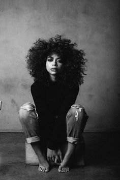 a black and white photo of a woman with curly hair