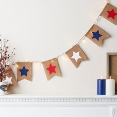 a decorated mantle with red, white and blue stars on burlap garlands