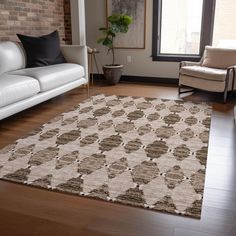 a living room filled with furniture and a large rug on top of a hard wood floor