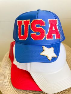 "The perfect accessory for the summer and all the patriotic events!! Hat comes with USA red patches and one white star patch on the bill. Choose your color hat to fit your style. We have several color options to choose from. Hat Details: 100% Polyester foam front, mesh back Structured, five-panel, mid-profile 3 ½\" crown Pre-curved visor with braid detailing Adjustable double snapback closure" White Baseball Cap Trucker Hat For 4th Of July, Summer Patriotic Trucker Hat With Curved Brim, White Baseball Cap For 4th Of July, Patriotic White Hat For Summer, White Trucker/basbeall Cap For 4th Of July, Patriotic Summer Snapback Trucker Hat, White Curved Brim Baseball Cap For 4th Of July, Adjustable Blue Trucker Hat For 4th Of July, Red Casual Baseball Cap For 4th Of July