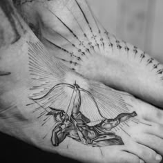 a man's foot with an angel tattoo on it