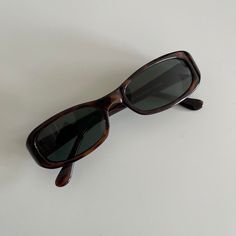 These slim rectangle sunglasses are your everyday classic. Featuring a red tortoise frame with smoke lens. This style is unisex. True genuine vintage sunglasses from the 90s.  - 400 uv  - new vintage from the 90s - includes sunglasses pouch  Measurements: frame width: 141mm Lens Height: 27mm Lens Width: 50 mm Bridge: 17 mm Arm temple: 140mm Hippie Glasses, Model Sunglasses, Cute Sunglasses, Vintage Fendi, Stylish Glasses, Rectangular Sunglasses, Rectangle Sunglasses, Eye Bags, Vintage Sunglasses