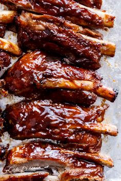 ribs covered in bbq sauce on top of parchment paper