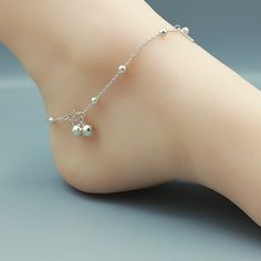 Sterling silver anklet with silver balls and tear drop charms. Comes with two 6mm bell. Length: 10 inches. Tear drop: 4 x 12 mm Ball: 3mm Price listed is for ONE piece. These anklets are made of 925 hypoallergenic sterling silver. All my pieces are sent in a gift box. I can include a personal message from you if needed. You are welcome to contact me at... bhavnakwintra1956@gmail.com More anklets https://www.etsy.com/shop/TheSilverGame?ref=seller-platform-mcnav&section_id=26713873 More hoops: Payal Designs Silver, Silver Chain Anklet, Silver Anklets Designs, Silver Payal, Fancy Jewelry Necklace, Charm Anklet, Pretty Jewelry Necklaces, Anklet Designs, Ankle Jewelry