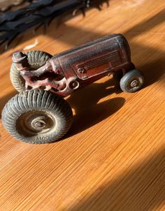 an old toy truck sitting on top of a wooden table