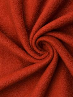 an orange fabric with a spiral design on it