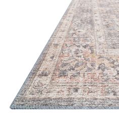 an antique rug with faded colors and patterns on the bottom, is shown in white