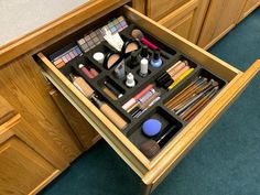 an open drawer with makeup and other items in it