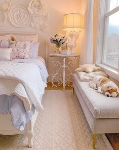 a white bed sitting next to a window with flowers on the headboard and foot board