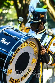 a man in uniform is playing the drums