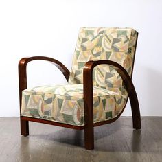 a chair sitting on top of a hard wood floor next to a white wall and wooden frame