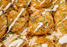 some fried food with white sauce and parsley on top