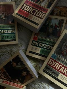 there are many books on the bed together in this room, including russian and english