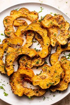 a white plate topped with sliced up squash