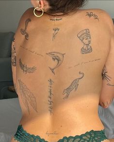 a woman with many tattoos on her back