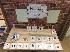 a wooden table topped with lots of different types of words and pictures on it's sides