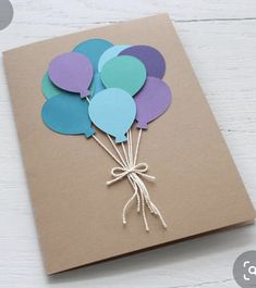 a card with some balloons tied to it