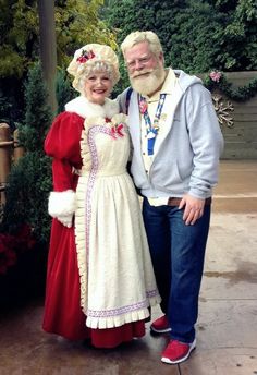 a man and woman dressed up as santa claus