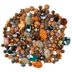 a bunch of beads that are laying on top of each other in different colors and shapes