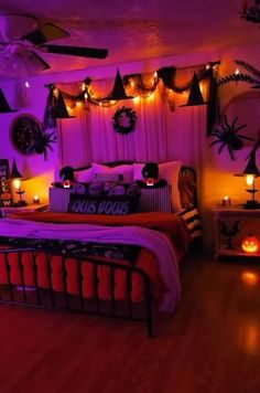 a bedroom decorated for halloween with purple lighting