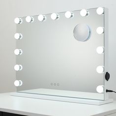 a vanity mirror with lights on top of it