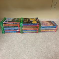 a stack of children's books sitting on the floor