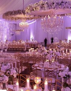 the tables are set up with candles and centerpieces for an elegant wedding reception